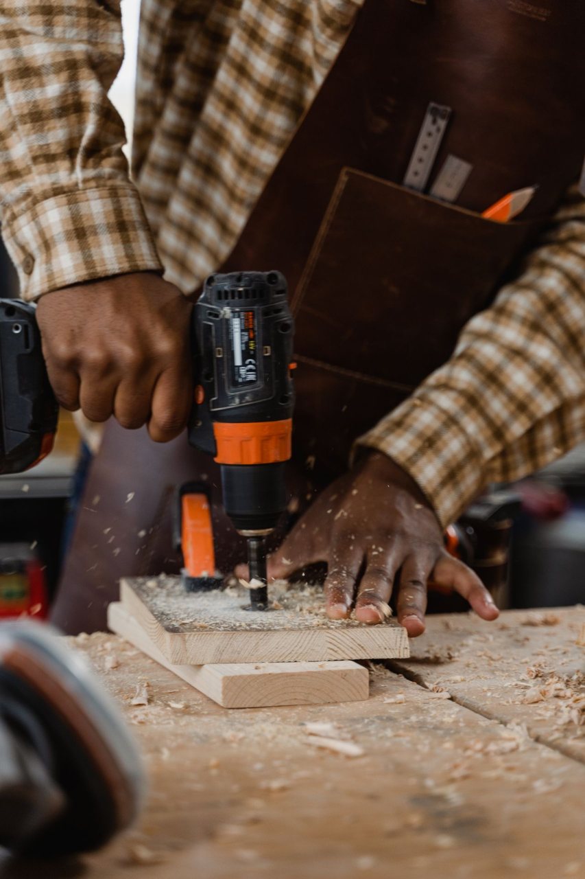 Free Close-up of a carpenter drilling wood, showcasing craftsmanship and attention to detail. Stock Photo