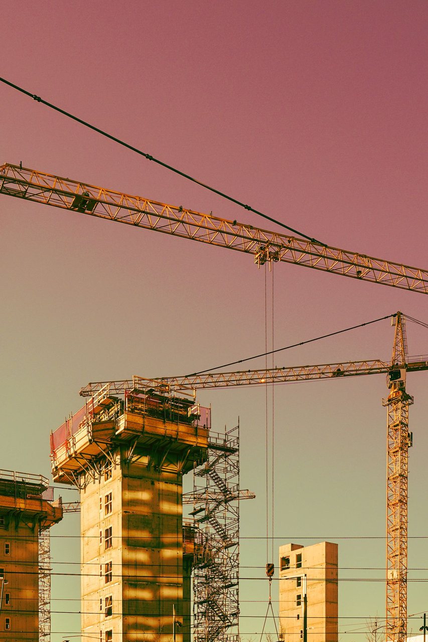 Free Vertical urban construction scene in Oslo featuring cranes and scaffolding. Stock Photo